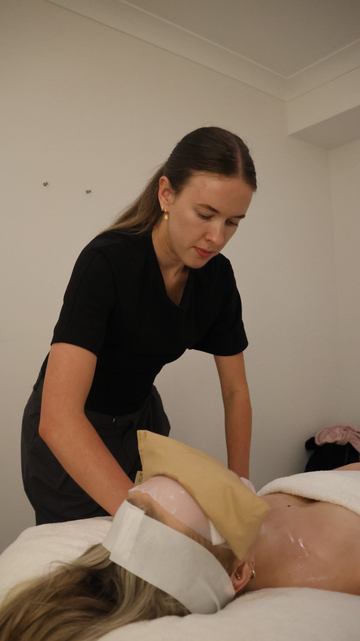 Jorja Vakulcyzk providing a relaxing facial treatment at The Skin Suite Collective day spa in Swan Valley.