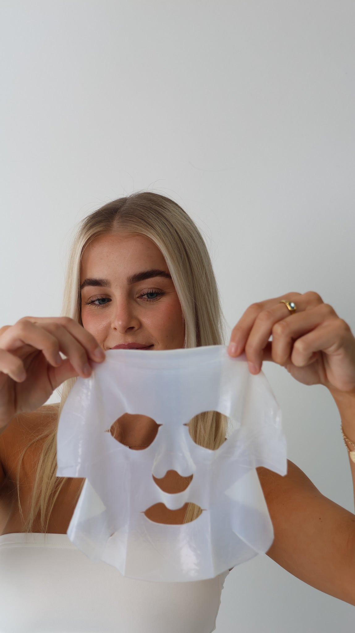 Client holding a Simka hydrating mask at The Skin Suite Collective in The Vines, supporting skin hydration, barrier health and a radiant complexion. Holistic Skin Treatments for Dehydration