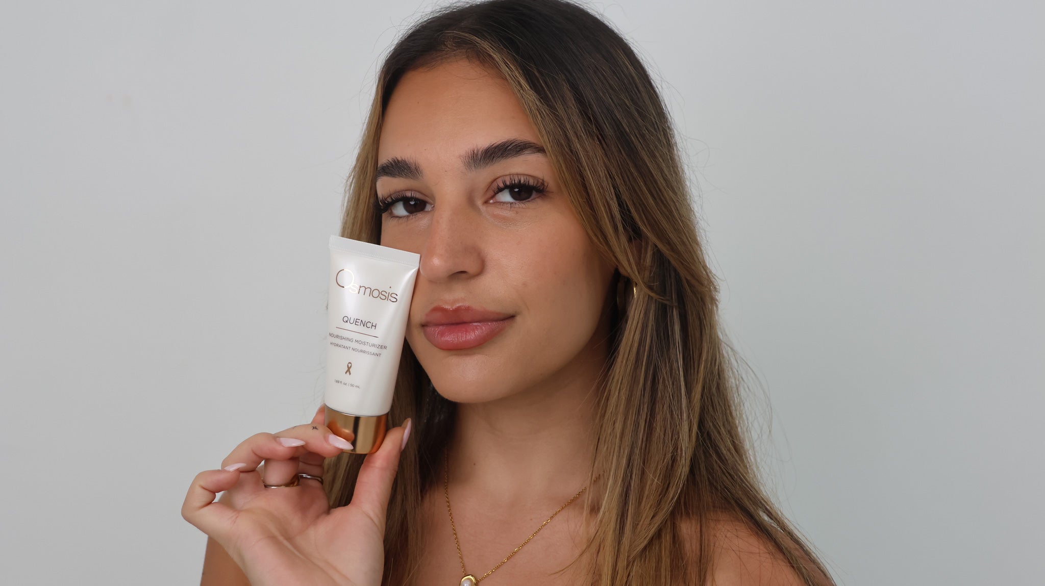 Model holding Osmosis Quench Hydrating Moisturiser, recommended to support skin hydration and barrier health alongside our Bespoke Buccal Ritual at The Skin Suite Collective in The Vines.