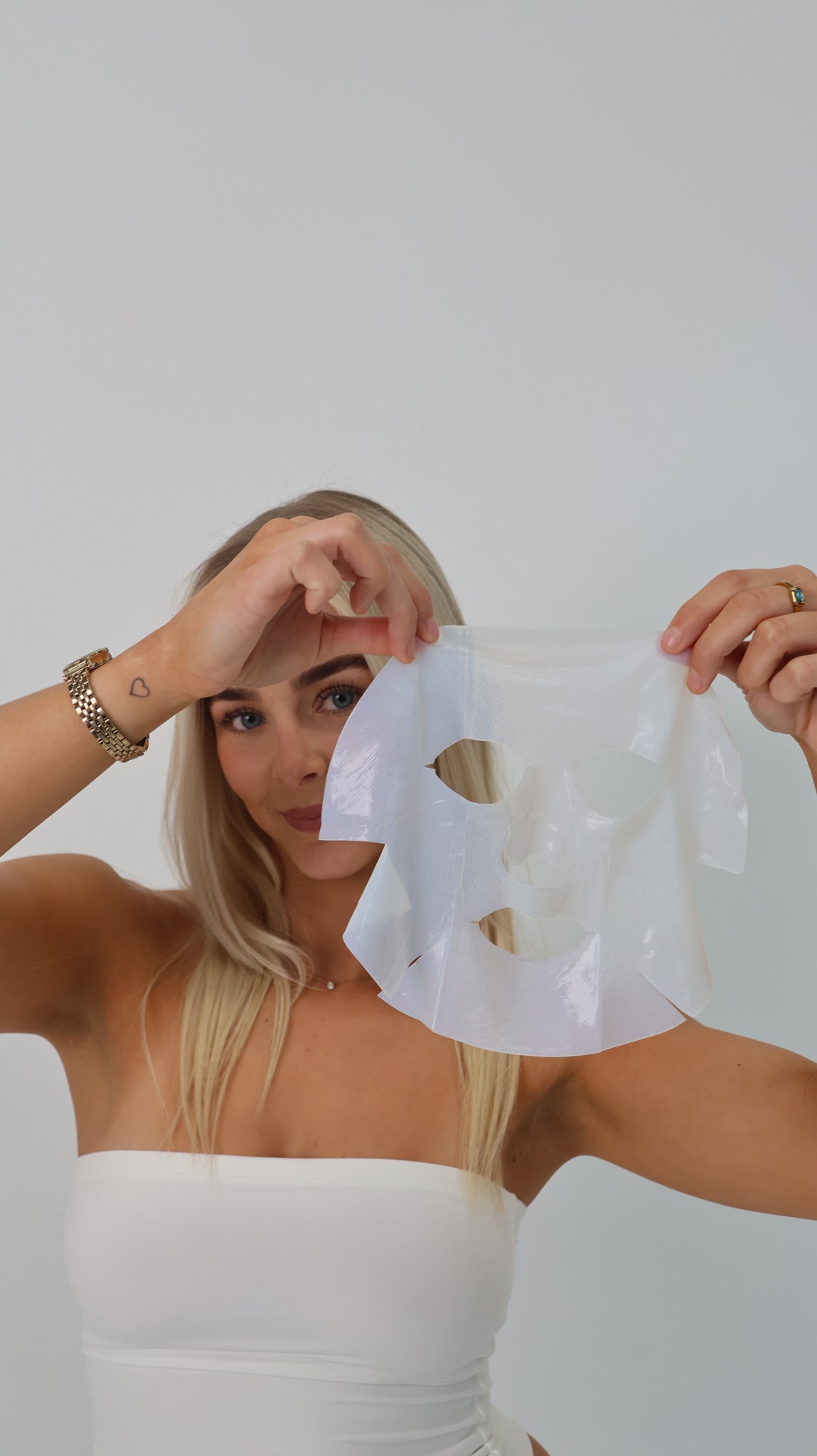 Client holding a Simka treatment mask for rosacea at The Skin Suite Collective, supporting skin barrier health and reducing redness.