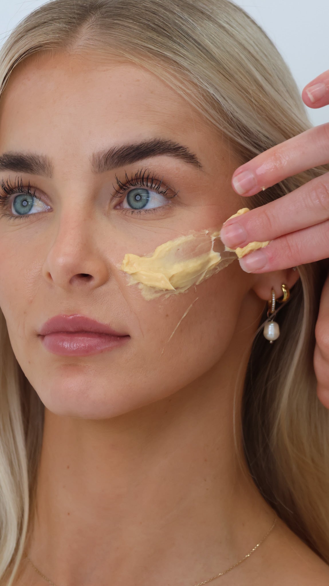 Model relaxing with a tropical mango mask during a luxury spa facial at The Skin Suite Collective in The Vines, designed to hydrate, nourish and restore radiant skin.